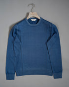 Gran Sasso Vintage merino wool knit. It has been garment dyed to achieve nice vintage look. This means it has more vivid compared to yarn dyed knitwear.   Vintage Merino is a core quality in our Gran Sasso collection. We offer a lighter quality for spring/summer and heavier for autumn/ winter season.   Crew neck 100% merino wool Vintage washed (garment dyed) Ribbed hem and cuffs Fashion fit Article: 55167/22792 Colore:   135 / Blue Made in Italy