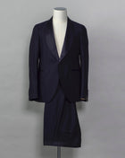 Tagliatore tuxedo with shawl collar. Unconstructed shoulder and half lined inside construction on jacket. Flat front trousers with satin waistband, matching to jacket lapel. Composition: 99% Virgin Wool Super 110's 1% Elastan Stretch Modello: S-PL18A01 LIS Color: Navy / B270 Unconstructed Unlined 1 button Shawl collar Jet pockets Back vent Flat front Made in Martina Franca, Italy