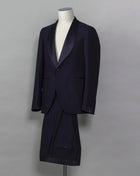 Tagliatore tuxedo with shawl collar. Unconstructed shoulder and half lined inside construction on jacket. Flat front trousers with satin waistband, matching to jacket lapel. Composition: 99% Virgin Wool Super 110's 1% Elastan Stretch Modello: S-PL18A01 LIS Color: Navy / B270 Unconstructed Unlined 1 button Shawl collar Jet pockets Back vent Flat front Made in Martina Franca, Italy