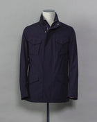 Montecore waterproof field jacket. Four pockets in front and adjustable waistband. Adjustable hood that can be folded inside the collar. So all the classical elements of a proper field jacket plus the added value of a waterproof and breathable technical  material. Four pockets in front Adjustable waist band Adjustable hood inside the collar Waterproof Breathable Taped seams  79% Polyester 21% Polyurethane Art. S04MUCT603 Col. 89 / Navy