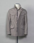 Montecore waterproof field jacket. Four pockets in front and adjustable waistband. Adjustable hood that can be folded inside the collar. So all the classical elements of a proper field jacket plus the added value of a waterproof and breathable technical  material. Four pockets in front Adjustable waist band Adjustable hood inside the collar Waterproof Breathable Taped seams 79% Polyester 21% Polyurethane Art. S04MUCT603 Col. 23 / Stone Grey