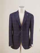 Perfect jacket for almost any semiformal occasion in autumn and winter.   Regular fit Fits true to the size. If in doubt of your size, please contact us  here Unlined Unconstructed shoulder 2 Buttons Side vents Notch lapel Patch pockets Composition: 72% wool, 25% cotton, 3% cashmere Color: Blue & Brown windowpane Modello: 2898 Article: 12145/3 Made in Italy