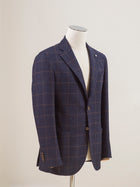 Perfect jacket for almost any semiformal occasion in autumn and winter.   Regular fit Fits true to the size. If in doubt of your size, please contact us  here Unlined Unconstructed shoulder 2 Buttons Side vents Notch lapel Patch pockets Composition: 72% wool, 25% cotton, 3% cashmere Color: Blue & Brown windowpane Modello: 2898 Article: 12145/3 Made in Italy