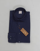 This navy casual Slimline jersey shirt is made of polyamide and elastane. The shirt is detailed with mother of pearl buttons, single cuffs and a cut away collar.

Composition: 73% Polyamide 27% Elastan
Article: 8407118269
Color: 190 / Navy
Slimline