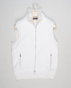 Fisherman's rib 3-ply pure cashmere sleeveless jacket. The metal zippers add a modern, functional touch. The faux fur lining provides warmth and comfort, making it ideal for colder days. The side pockets complete the stylish and practical design.

Outer composition: 100% cashmere
Inner composition: 100% Faux fur
Zipped side pockets
Two-way zipper
Art 23144 15581
Col 001 Cream White
Regular fit
Made in Italy Gran Sasso Eco-Fur & Cashmere Ribbed Vest / White