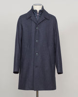 Iconic Herno wool coat in refined glencheck, balancing navy and blue for understated luxury. Fully lined for structured layering across seasons. Features a detachable bib for versatile styling—wear it integrated for classic formality or remove for a streamlined silhouette. Italian craftsmanship and meticulous tailoring define this essential investment piece. Herno Lined Glencheck Wool Coat / Navy &amp; Blue