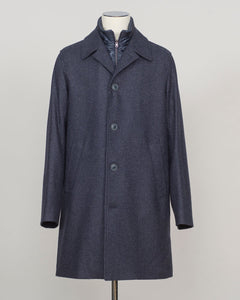 Iconic Herno wool coat in refined glencheck, balancing navy and blue for understated luxury. Fully lined for structured layering across seasons. Features a detachable bib for versatile styling—wear it integrated for classic formality or remove for a streamlined silhouette. Italian craftsmanship and meticulous tailoring define this essential investment piece. Herno Lined Glencheck Wool Coat / Navy &amp; Blue