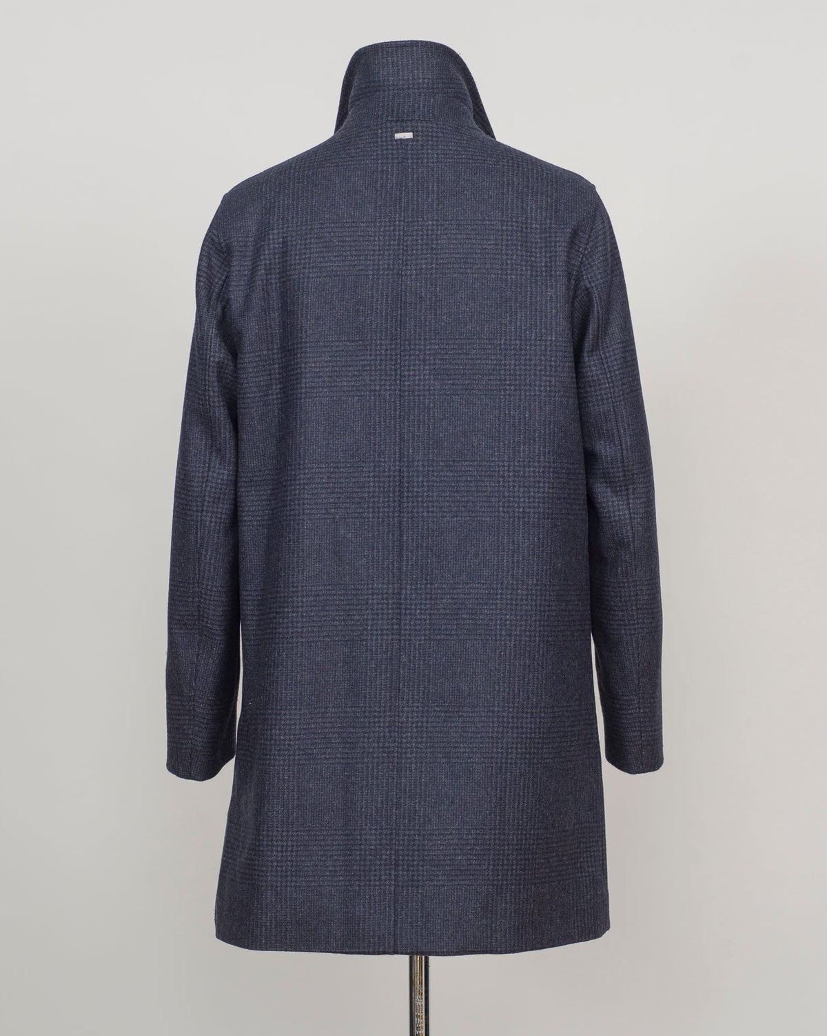 Iconic Herno wool coat in refined glencheck, balancing navy and blue for understated luxury. Fully lined for structured layering across seasons. Features a detachable bib for versatile styling—wear it integrated for classic formality or remove for a streamlined silhouette. Italian craftsmanship and meticulous tailoring define this essential investment piece. Herno Lined Glencheck Wool Coat / Navy & Blue