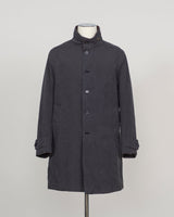 A dark charcoal gray mid-length coat with a high stand collar and front buttons, displayed on a mannequin torso against a light gray studio background.