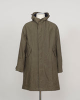 An olive green hooded raincoat displayed on a white mannequin torso against a light gray studio background.