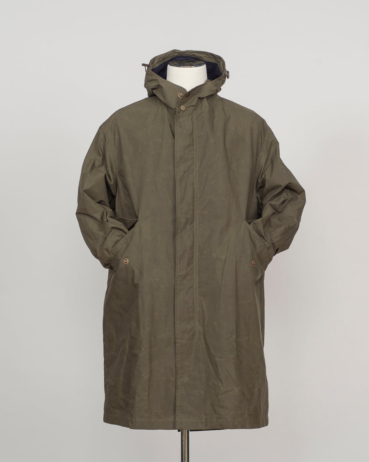 An olive green hooded parka jacket displayed on a white mannequin torso against a light gray studio background.
