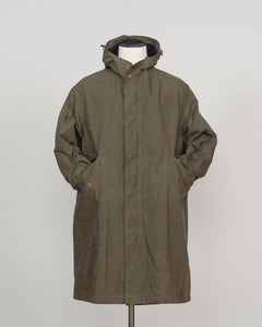 An olive green hooded parka jacket displayed on a white mannequin torso against a light gray studio background.