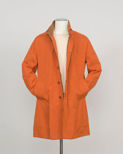 An orange mid-length coat with a brown collar lining, displayed on a white mannequin torso against a light gray background.