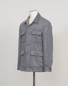 A gray textured utility jacket displayed on a mannequin torso against a light gray studio background.
