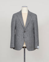 A gray textured wool blazer displayed on a cream-colored mannequin torso, set against a plain light gray background.