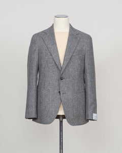 A gray textured wool blazer displayed on a cream-colored mannequin torso, set against a plain light gray background.