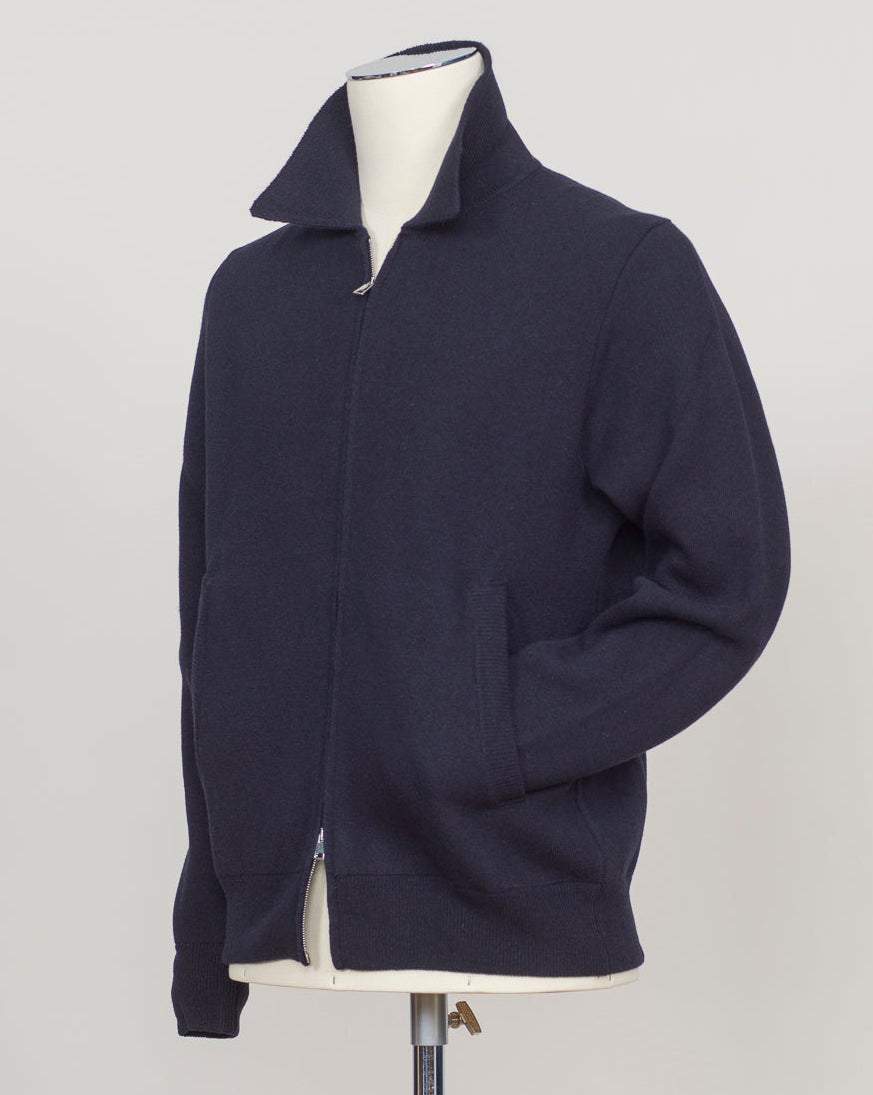 Knitted Full-Zip Bomber in navy. Premium Italian-made jacket that combines classic style with exceptional comfort. Crafted from a high-quality blend of 87% wool, 8% cashmere, and 5% polyamide, it offers a luxurious feel and excellent warmth. This versatile piece features a convenient full-zip front and a refined knitted texture, making it perfect for both smart-casual and relaxed everyday wear. FLY3 Knitted Full-Zip Bomber / Navy
