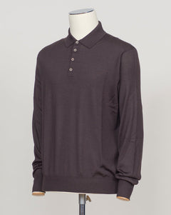 A refined three-ply knit polo crafted from a luxurious blend of merino wool, cashmere, and silk. The dark brown tone offers versatility across seasons, while the natural fiber composition ensures breathability and a subtle sheen. Designed for the discerning wearer who values both comfort and understated elegance. Gran Sasso Wool Cashmere &amp; Silk Polo / Dark Brown