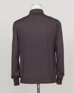 A refined three-ply knit polo crafted from a luxurious blend of merino wool, cashmere, and silk. The dark brown tone offers versatility across seasons, while the natural fiber composition ensures breathability and a subtle sheen. Designed for the discerning wearer who values both comfort and understated elegance. Gran Sasso Wool Cashmere &amp; Silk Polo / Dark Brown