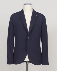 Refined elegance in pure merino. Gran Sasso's knitted blazer in navy delivers structured sophistication without formality—a foundation piece that transitions seamlessly from office to evening. Engineered for layering and designed to last. Gran Sasso Knitted Blazer / Navy 
