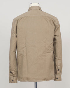 A beige long-sleeve utility jacket displayed on a mannequin torso, viewed from the back against a plain light gray background. Ghirardelli Heavy Twill Overshirt / Taupe Heavy twill overshirt in taupe. Crafted from substantial cotton twill for durability and structure. Classic overshirt silhouette layers effortlessly over knitwear or worn standalone. Designed for refined casual wear and everyday versatility.&nbsp;