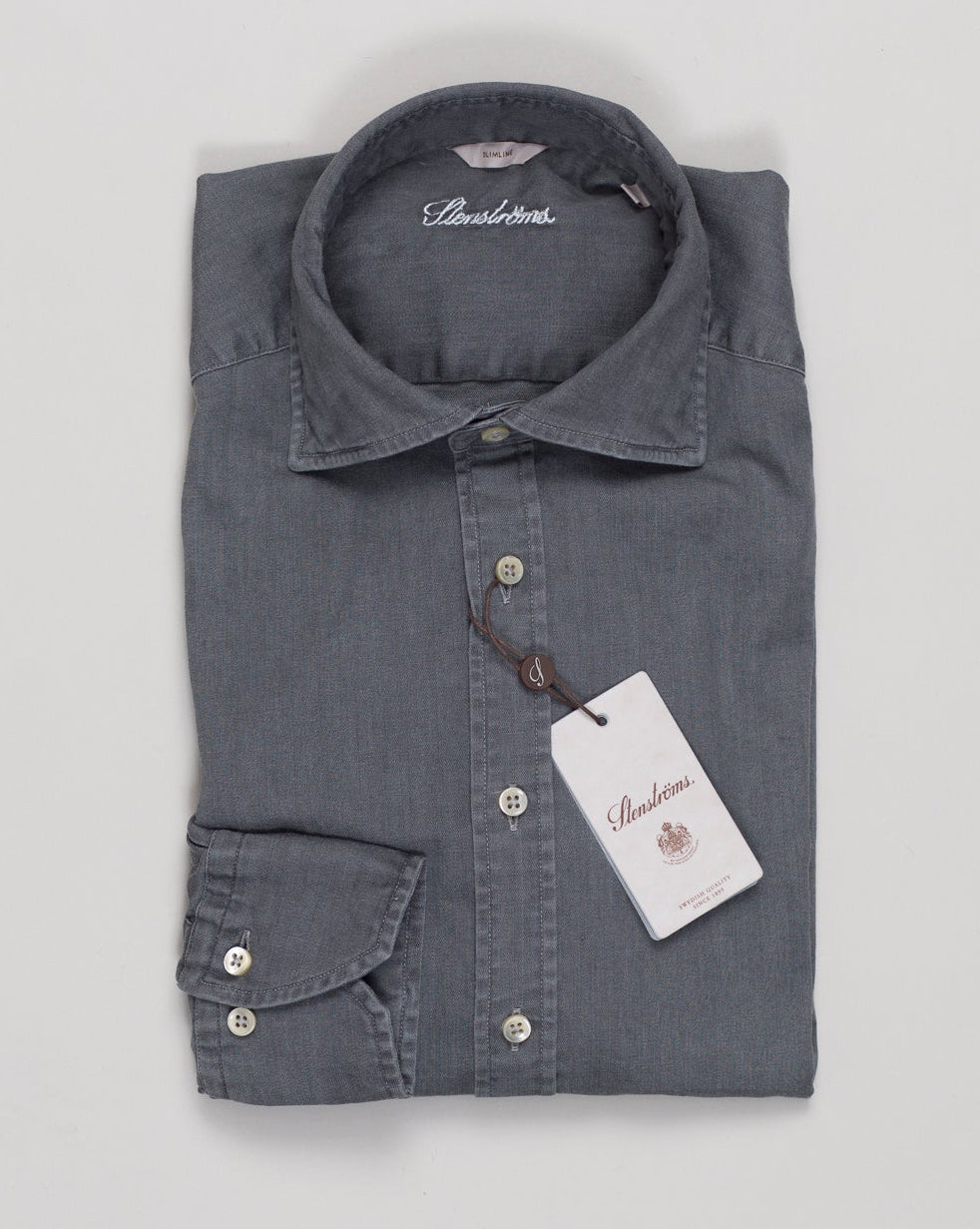 A timeless denim shirt in soft grey, crafted from premium stretch cotton for effortless comfort and movement. The classic design pairs seamlessly with tailored trousers or casual wear, making it an essential foundation piece for any wardrobe. Stenströms' attention to detail ensures superior construction and lasting quality. Stenströms Denim Stretch Shirt / Grey