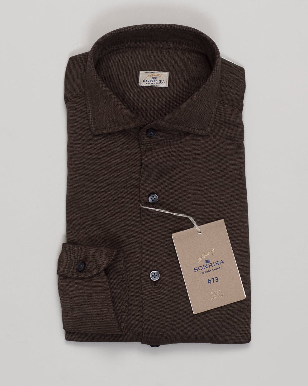 Soft cotton and lyocell blend delivers effortless comfort with natural drape. The jersey construction moves with you while maintaining its shape. A versatile brown tone pairs seamlessly with tailored trousers or casual wear. Relaxed fit with refined details for everyday sophistication. Sonrisa Cotton & Lyocell Jersey Shirt / Brown