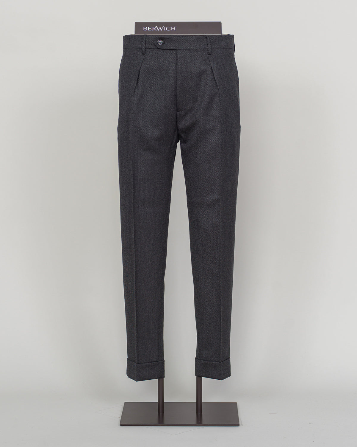 Italian tailoring meets understated elegance in these Berwich Chiaia trousers. Crafted from long wool covert fabric in dark grey, they deliver refined structure and subtle texture. A timeless foundation piece for discerning wardrobes—pair with blazers or knitwear for effortless sophistication.&nbsp;