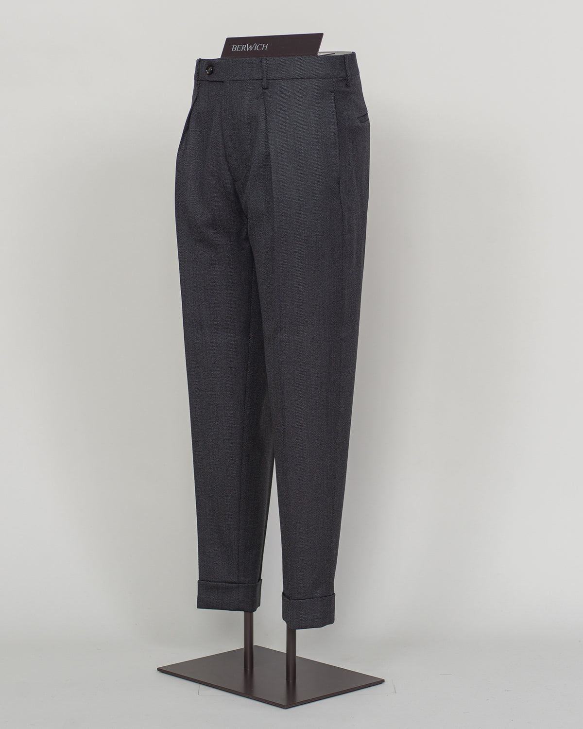 Italian tailoring meets understated elegance in these Berwich Chiaia trousers. Crafted from long wool covert fabric in dark grey, they deliver refined structure and subtle texture. A timeless foundation piece for discerning wardrobes—pair with blazers or knitwear for effortless sophistication.&nbsp;