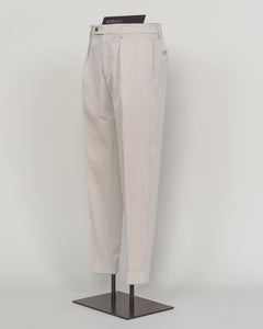 Crafted from a refined blend of wool and cotton, these Berwich trousers exemplify Italian tailoring at its finest. The long-staple gabardine weave delivers a subtle lustre and exceptional drape, while the balanced fibre composition ensures breathability and durability across seasons.

The versatile chalk tone pairs seamlessly with sport coats, knitwear, and tailored jackets. Clean lines and a measured cut reflect contemporary menswear proportions without compromise on classic elegance.

A foundation piece f