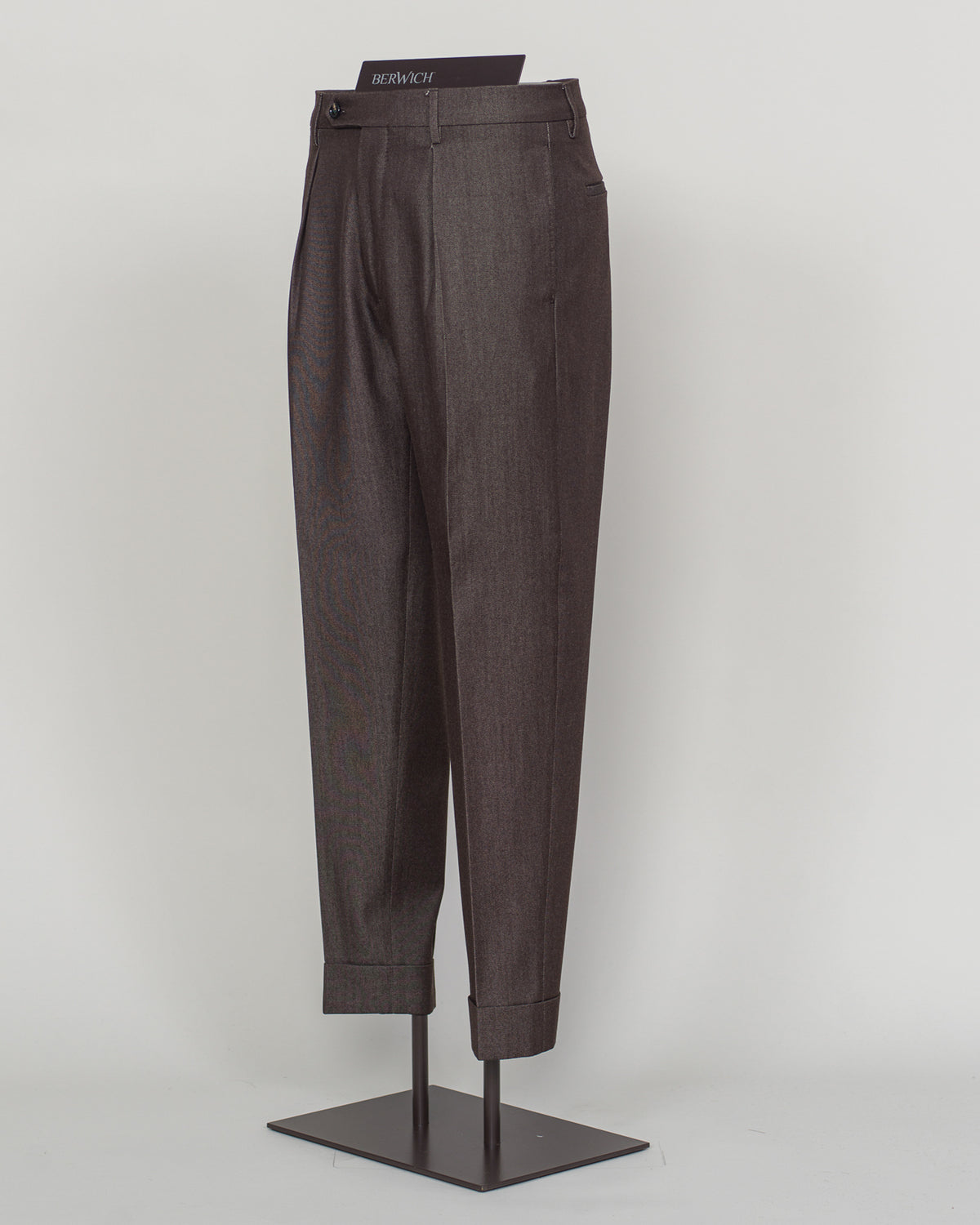 Crafted from a refined blend of wool and cotton, these Berwich trousers exemplify Italian tailoring at its finest. The long-staple gabardine weave delivers a subtle lustre and exceptional drape, while the balanced fibre composition ensures breathability and durability across seasons.

The versatile brown tone pairs seamlessly with sport coats, knitwear, and tailored jackets. Clean lines and a measured cut reflect contemporary menswear proportions without compromise on classic elegance.

A foundation piece f