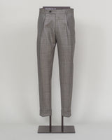Berwich's Chiaia trousers showcase Italian tailoring heritage with a refined long glencheck pattern in warm greige. Cut with a contemporary silhouette and finished with precision pleating, these trousers balance classic structure with modern sophistication. The carefully selected fabric drapes with quiet elegance, making them an essential foundation for curated menswear wardrobes that demand both substance and understated style.