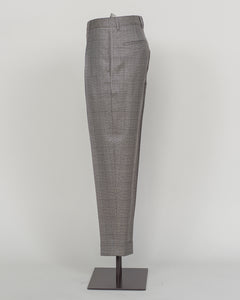 Berwich's Chiaia trousers showcase Italian tailoring heritage with a refined long glencheck pattern in warm greige. Cut with a contemporary silhouette and finished with precision pleating, these trousers balance classic structure with modern sophistication. The carefully selected fabric drapes with quiet elegance, making them an essential foundation for curated menswear wardrobes that demand both substance and understated style.