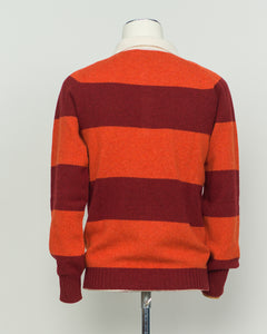 A timeless rugby polo crafted from pure wool, featuring Harley of Scotland's signature striped pattern in warm orange and red tones. The structured knit delivers excellent breathability and natural temperature regulation, ideal for layering or standalone wear. Classic collar and button placket with a relaxed yet refined fit that suits both casual and smart-casual settings. A versatile staple for the discerning wardrobe.