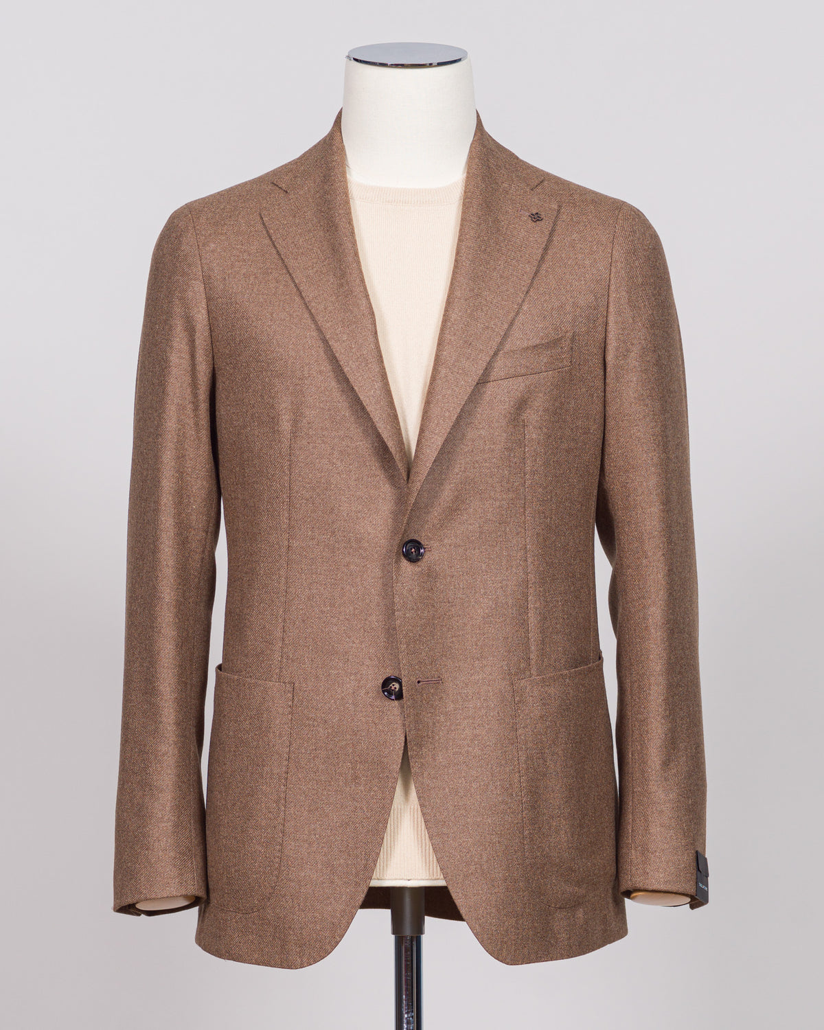 Refined tailoring meets supreme comfort in this Tagliatore sport jacket, crafted from 93% wool and 3% cashmere. The light brown tone offers versatile styling across seasons, while the luxurious blend delivers warmth without bulk. A wardrobe essential for the discerning gentleman seeking quality construction and understated elegance. Tagliatore Wool & Cashmere Jacket / Light Brown