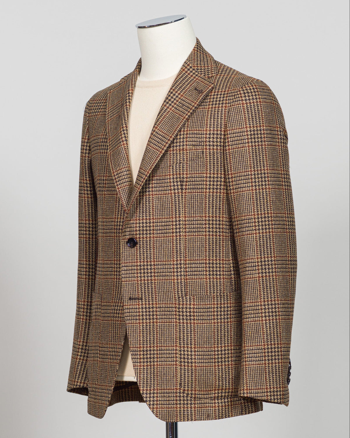 Classic Prince of Wales check blazer in rich brown tones. Tailored construction with refined detailing, perfect for elevating everyday wear or layering with knitwear. Italian craftsmanship meets timeless menswear design—an essential piece for the discerning wardrobe. Tagliatore Prince Of Wales Jacket / Brown
