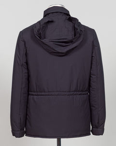 A dark navy blue quilted jacket displayed on a white mannequin torso against a neutral light gray The Gran Sasso Padded Nylon Jacket in navy delivers genuine warmth without the weight. Its lightweight thermowadding construction and refined collar offer understated sophistication—equally at home over a dress shirt or layered with knitwear. Italian craftsmanship meets everyday practicality: polished for client meetings, reliable for daily wear, and versatile enough to become your most trusted layerbackground.