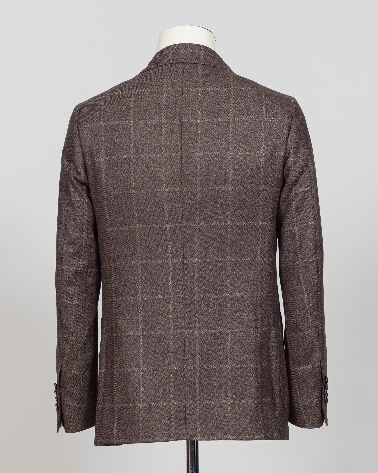Crafted in Naples by Luigi Borrelli, this windowpane sport jacket exemplifies Italian tailoring precision. The structured brown pattern delivers versatile sophistication—pair it with charcoal trousers for boardroom presence or lighter separates for weekend elegance. Classic cut accommodates layering while maintaining a refined silhouette. A cornerstone piece for discerning menswear collections.