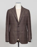 Crafted in Naples by Luigi Borrelli, this windowpane sport jacket exemplifies Italian tailoring precision. The structured brown pattern delivers versatile sophistication—pair it with charcoal trousers for boardroom presence or lighter separates for weekend elegance. Classic cut accommodates layering while maintaining a refined silhouette. A cornerstone piece for discerning menswear collections.