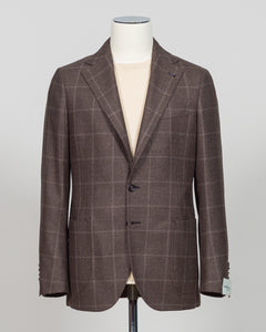 Crafted in Naples by Luigi Borrelli, this windowpane sport jacket exemplifies Italian tailoring precision. The structured brown pattern delivers versatile sophistication—pair it with charcoal trousers for boardroom presence or lighter separates for weekend elegance. Classic cut accommodates layering while maintaining a refined silhouette. A cornerstone piece for discerning menswear collections.