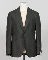 A dark gray textured tweed blazer displayed on a cream-colored mannequin torso against a light gray background. A timeless sport jacket tailored for refined occasions. This Caruso tweed delivers sophisticated texture in a rich dark green, anchoring tailored looks with understated elegance. The natural fiber construction promises durability and breathability, while the classic cut pairs seamlessly with dress trousers or smart casual wear.

Caruso's meticulous craftsmanship ensures a jacket built to last—one 