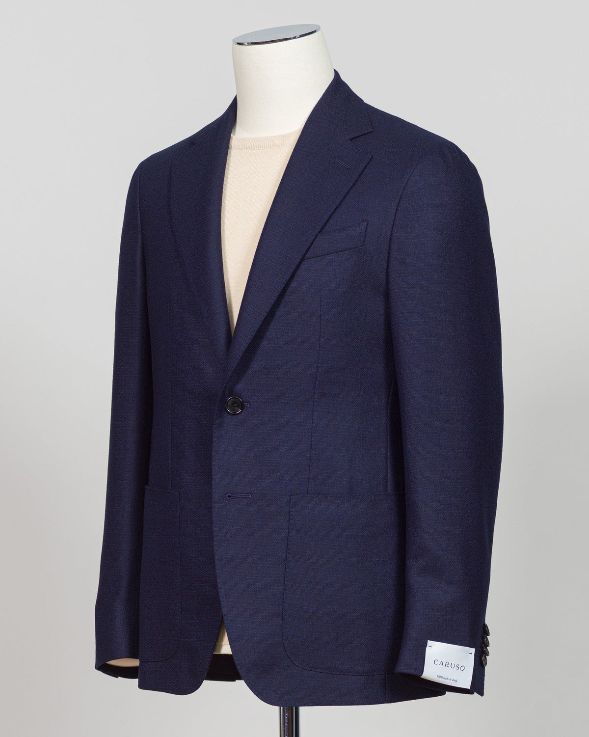 Caruso flannel sport jacket crafted in navy wool with tailored precision. This versatile layer features refined construction detailing and a structured silhouette designed for sophisticated menswear styling. Soft woolen fabric offers warmth and texture while maintaining a polished appearance, making it an essential piece for layering across seasons. Ideal for both professional and casual refined occasions, this jacket pairs seamlessly with dress trousers, chinos, or tailored separates. The classic navy tone