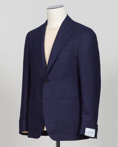 Caruso flannel sport jacket crafted in navy wool with tailored precision. This versatile layer features refined construction detailing and a structured silhouette designed for sophisticated menswear styling. Soft woolen fabric offers warmth and texture while maintaining a polished appearance, making it an essential piece for layering across seasons. Ideal for both professional and casual refined occasions, this jacket pairs seamlessly with dress trousers, chinos, or tailored separates. The classic navy tone