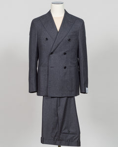 A dark gray double-breasted suit with a subtle micro-check pattern, displayed on a mannequin against a light gray background. Refined elegance in a timeless double-breasted silhouette. This Caruso suit pairs the warmth of quality flannel with sophisticated tailoring, delivering understated luxury suited to both boardroom and evening occasions. Dark grey ensures versatility across your wardrobe while the construction speaks to meticulous craftsmanship and enduring style.Caruso Double-Breasted Flannel Suit / 