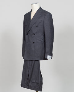 A dark gray double-breasted suit with a subtle micro-houndstooth pattern, displayed on a mannequin against a light gray background. Refined elegance in a timeless double-breasted silhouette. This Caruso suit pairs the warmth of quality flannel with sophisticated tailoring, delivering understated luxury suited to both boardroom and evening occasions. Dark grey ensures versatility across your wardrobe while the construction speaks to meticulous craftsmanship and enduring style.Caruso Double-Breasted Flannel S