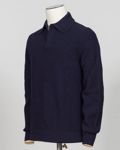 A dark navy blue ribbed knit polo sweater displayed on a white mannequin torso against a light gray background.  Timeless ribbed polo in navy from Gran Sasso, Italian craftsmanship meets understated elegance. Refined knit construction sits comfortably between casual and formal wear. An essential layer for the discerning wardrobe. Gran Sasso Ribbed Polo / Navy