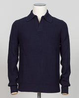 A dark navy blue ribbed knit polo sweater displayed on a white mannequin torso against a light gray background.  Timeless ribbed polo in navy from Gran Sasso, Italian craftsmanship meets understated elegance. Refined knit construction sits comfortably between casual and formal wear. An essential layer for the discerning wardrobe. Gran Sasso Ribbed Polo / Navy