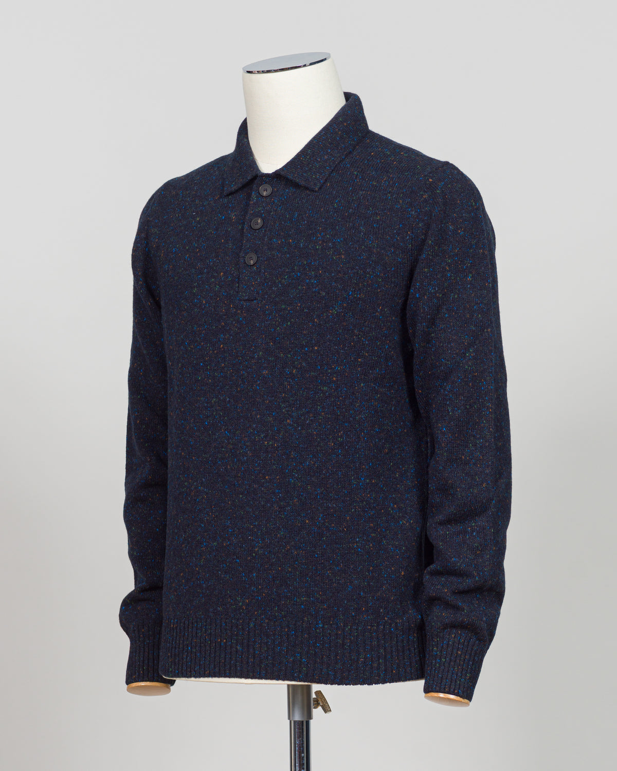 A timeless polo crafted from luxurious Donegal yarn, blending Italian heritage with understated elegance. The textured weave creates subtle visual interest while maintaining the versatility of a classic navy foundation. Refined construction and premium materials make this piece equally at home in casual settings or layered for sophisticated warmth. A staple worthy of investment.