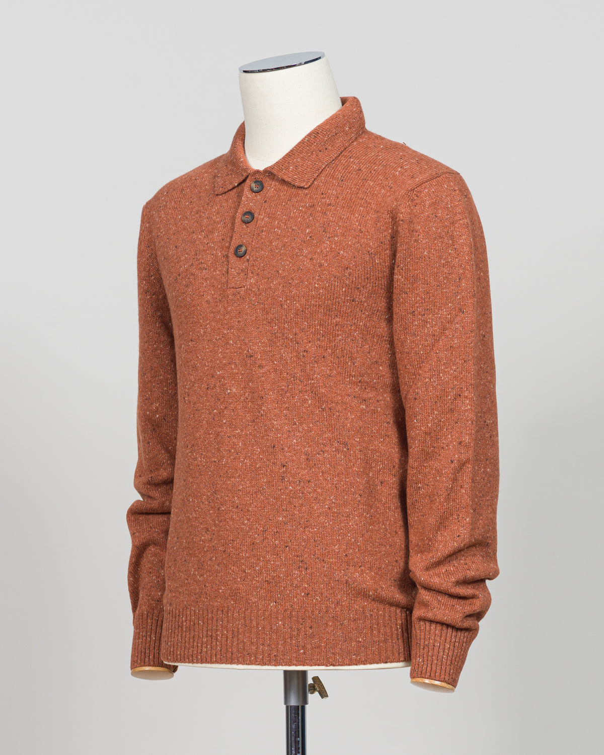 A timeless polo crafted from luxurious Donegal yarn, blending Italian heritage with understated elegance. The textured weave creates subtle visual interest while maintaining the versatility of a classic orange foundation. Refined construction and premium materials make this piece equally at home in casual settings or layered for sophisticated warmth. A staple worthy of investment.