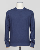 A navy blue long-sleeve knit sweater displayed on a white mannequin torso against a light gray studio background. Italian craftsmanship meets timeless elegance in this Gran Sasso vintage crewneck. Constructed from premium yarns with meticulous attention to detail, this navy essential delivers versatile sophistication for refined wardrobes. The classic crew silhouette and refined knit construction ensure enduring style and comfort across seasons. A foundation piece worthy of investment. Gran sasso blue